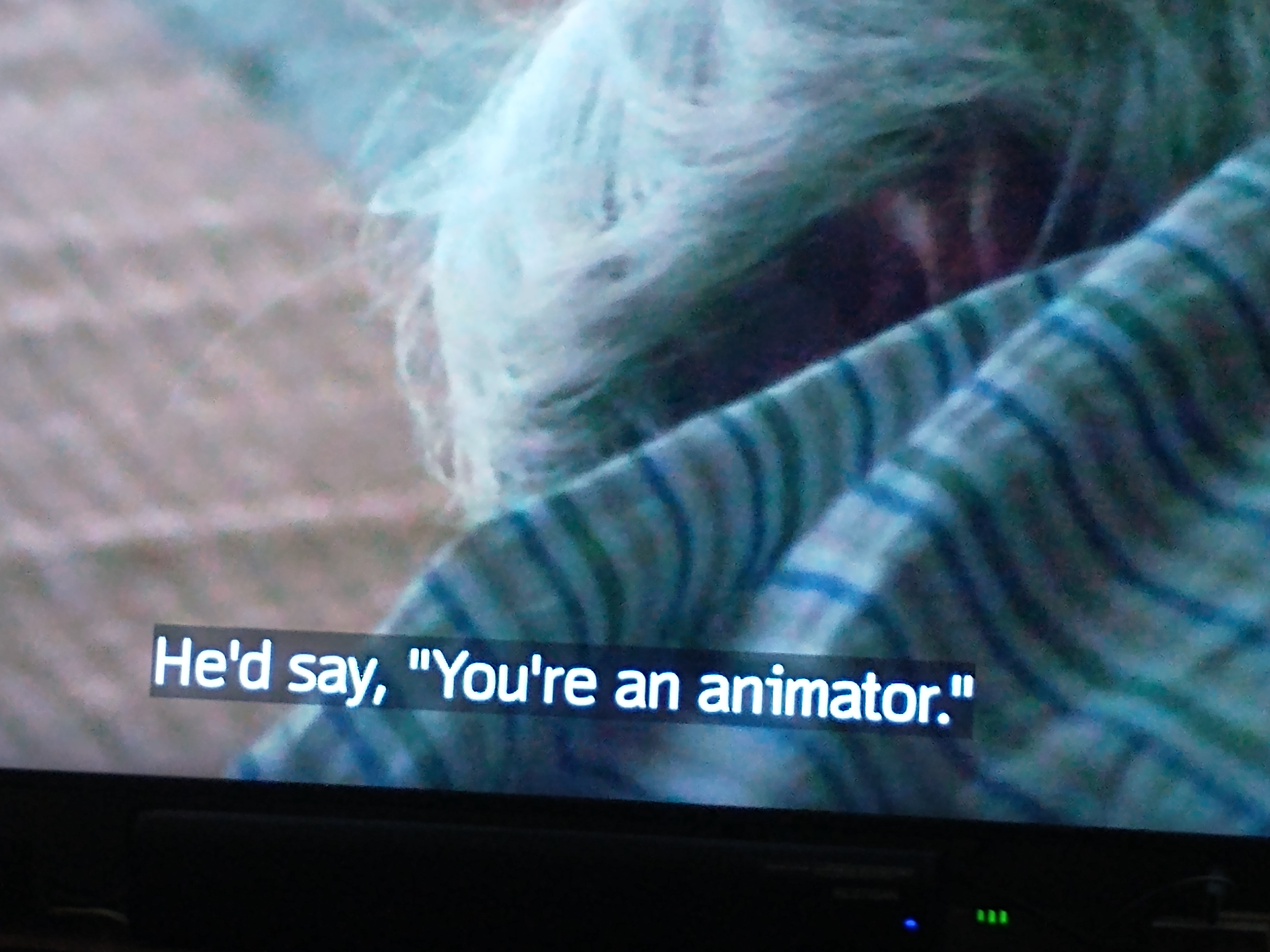Back of white-haired man with subtitle saying He'd say you're an animator 